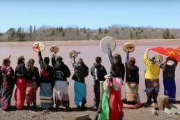 Indigenous women looking out on a river
